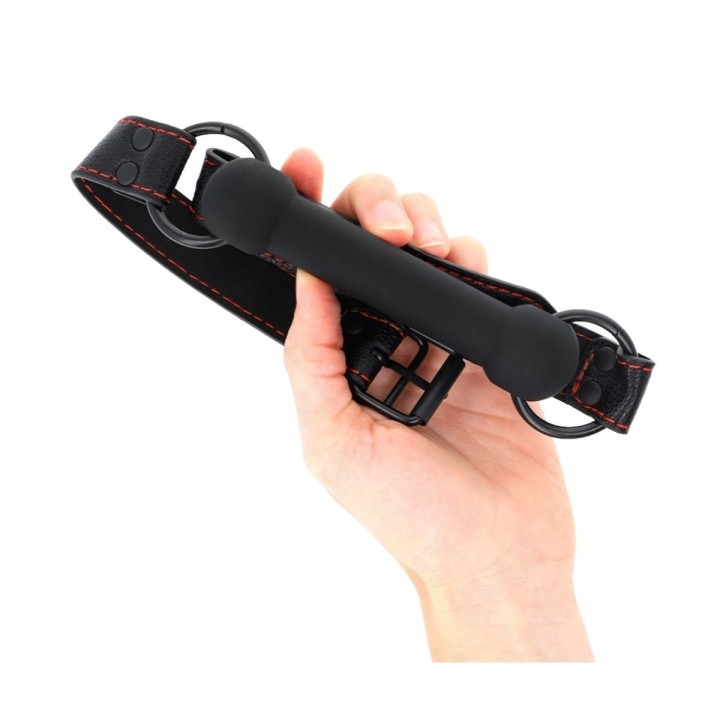 Mordaza KINK forma hueso negra, vista completa en mano